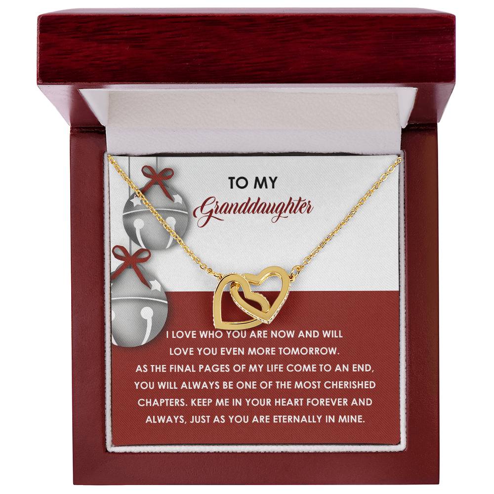 The Granddaughter-To An End - Interlocking Hearts Necklace, adorned with cubic zirconia crystals, is thoughtfully presented in a red jewelry box and includes a touching message about love and cherished memories for a granddaughter.