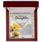 An open wooden jewelry box showcasing the Daughter-Journey Home - Interlocking Hearts Necklace, crafted from gleaming gold. The inside lid features a heartfelt letter titled "To My Daughter," with a delicate yellow flower design, making this keepsake as enduring as surgical steel and sparkling cubic zirconia.