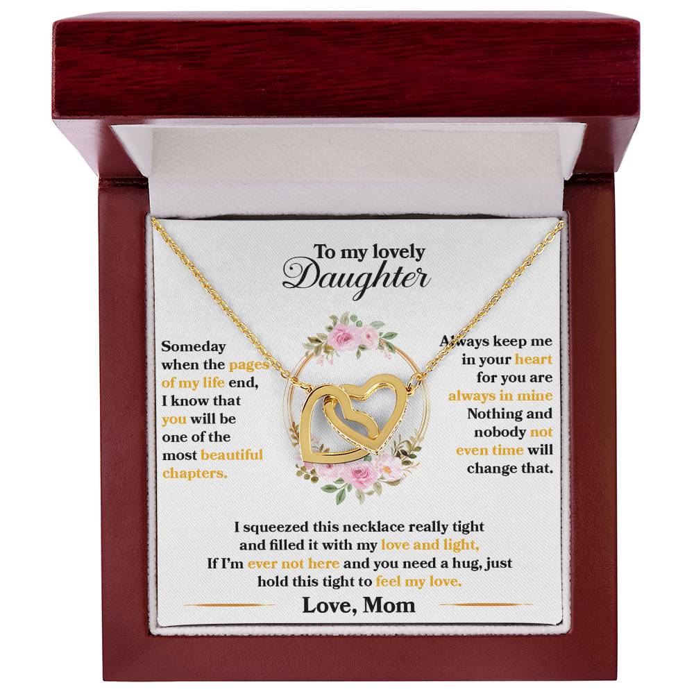 A necklace featuring an "To My Lovely Daughter, Hold This Tight To Feel My Love" Interlocking Hearts pendant from ShineOn Fulfillment in a gift box with a sentimental message from a mother to a daughter.