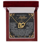 The Mom-God's Masterpiece - Interlocking Hearts Necklace, with a rose gold finish, comes in a red box and includes a decorative card that says "God's masterpiece is Mother," featuring a heartfelt poem celebrating mothers' invaluable role.