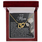 The Mom-Guiding Light - Interlocking Hearts Necklace, featuring gold intertwined heart pendants, is elegantly presented in a red gift box. The inside lid displays a touching message to "Mom" with a rose image accented by sparkling cubic zirconia crystals.