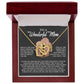 The Mom-More To Me - Interlocking Hearts Necklace features intertwined hearts with a mother-child figure adorned with cubic zirconia crystals in a rose gold finish jewelry box. The lid reads "To a Wonderful Mom," with a heartfelt message inside.