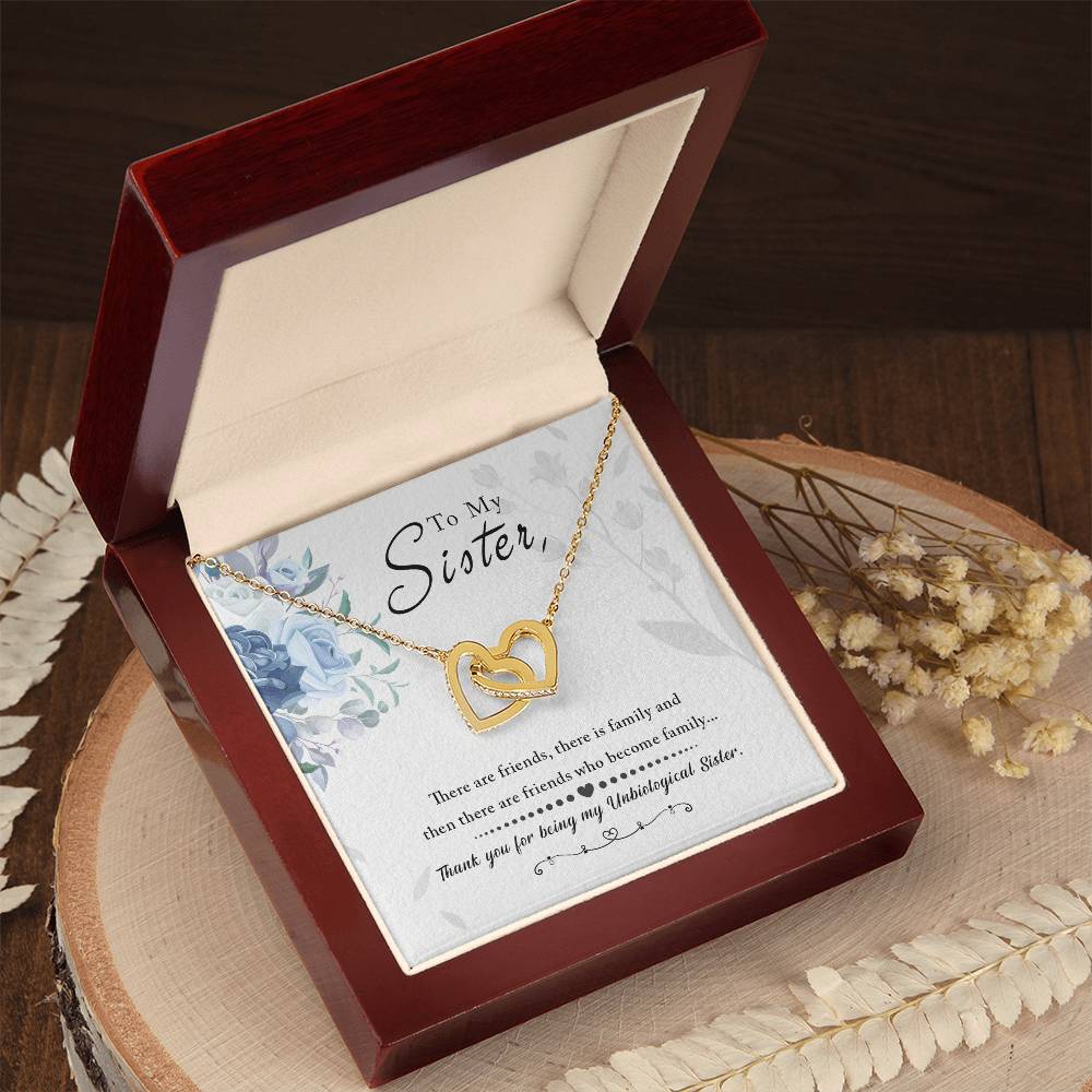 An "To My Sister, Thank You For Everything" Interlocking Hearts necklace in a gift box with a sentimental message for a sister by ShineOn Fulfillment.