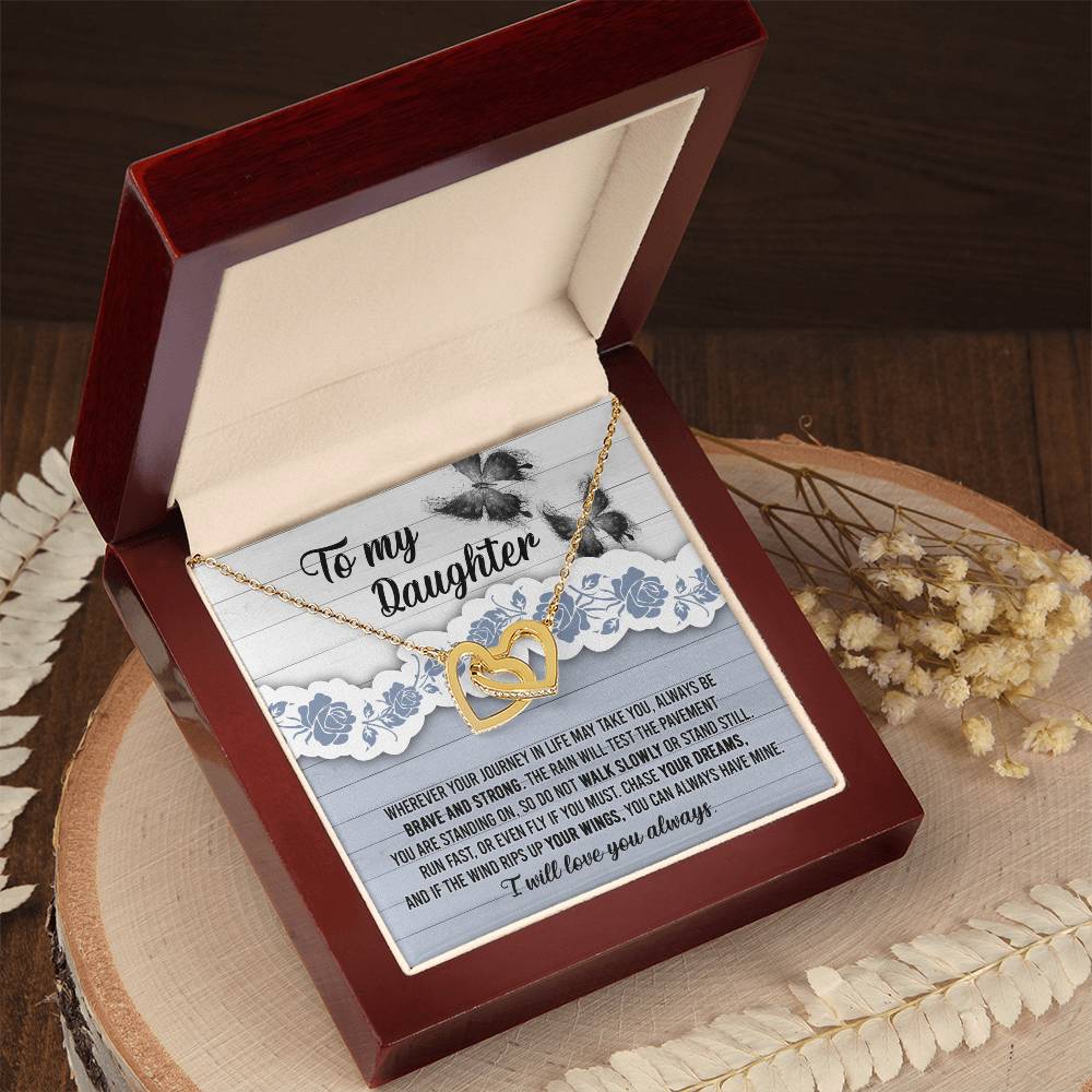 The "To Daughter, Always Have Mine - Interlocking Hearts Necklace," adorned with cubic zirconia crystals, is beautifully presented against a decorative card that inspires bravery, strength, and the pursuit of dreams. The message is addressed "To my Daughter" and concludes with "I will love you always.