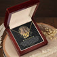 A personalized gift awaits in an open wooden box: the "To Mom, My Everything - Interlocking Hearts Necklace" adorned with cubic zirconia crystals. The lid displays a heartfelt message to "Dear Mom.