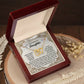 An open wooden box displays the "Daughter-Beautiful And Eternal - Interlocking Hearts Necklace," sparkling with cubic zirconia and a rose gold finish, accompanied by an ornate card carrying an inspirational message for a daughter.