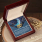 The Daughter-Grown Heart - Interlocking Hearts Necklace, featuring a surgical steel and rose gold finish, is beautifully presented in an open wooden box. The interior card, "To My Beautiful Daughter," carries a heartfelt message, while decorative dried flowers complete the display.