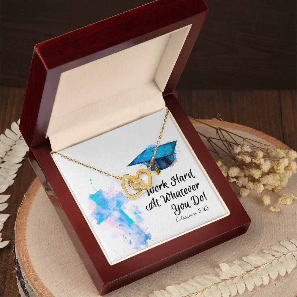 A Work Hard - Interlocking Hearts Necklace with cubic zirconia crystals, accompanied by a motivational message in a wooden box, perfect as an anniversary gift from ShineOn Fulfillment.
