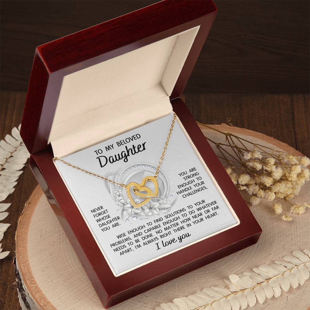 The "To Daughter, Always Right There - Interlocking Hearts Necklace" features a stunning interlocking hearts design with a rose gold finish and sparkling cubic zirconia crystals. It comes in a gift box that includes a heartfelt message for your beloved daughter, offering support, wisdom, and love.