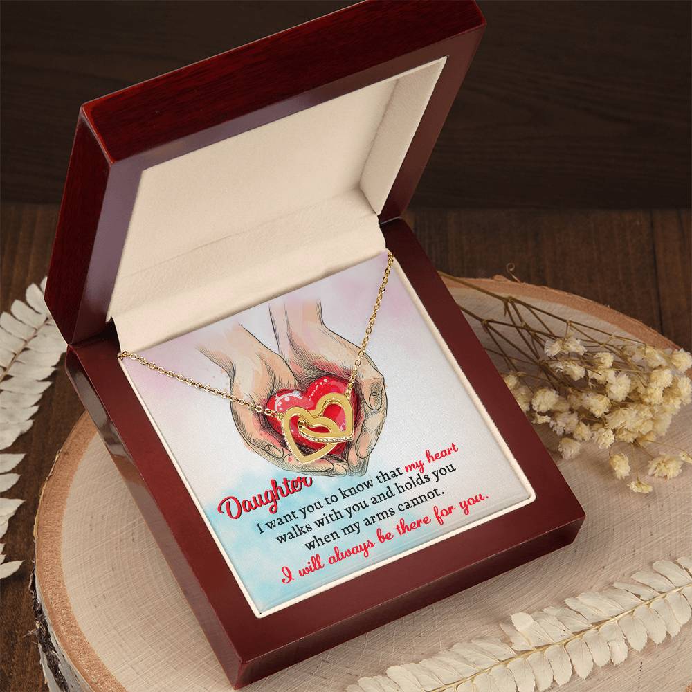 A high quality polished surgical steel necklace with two interlocking hearts is placed over an illustration of hands holding a red heart. Text reads: "Daughter, I want you to know that my heart walks with you and holds you when my arms cannot. I will always be there for you.
Product Name: To Daughter, Always Be There - Interlocking Hearts Necklace.