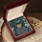 The Daughter-Happiest Person Interlocking Hearts Necklace features a rose gold finish and cubic zirconia crystals. It is beautifully presented in a wooden box with a card titled "To My Daughter" that conveys a heartfelt message.