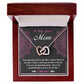 The Bonus Mom-An Amazing Mom Interlocking Hearts Necklace, featuring silver and rose gold finishes, is beautifully presented in an open wooden box with a card saying "To My Bonus Mom" and a heartfelt message. Adorned with cubic zirconia crystals, it's a sparkling gift of love and gratitude.