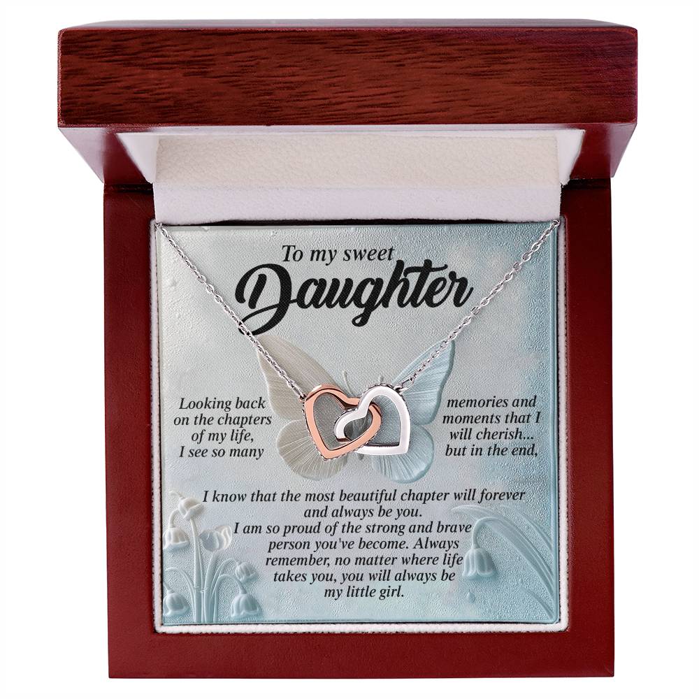 The Daughter-Beautiful Chapter - Interlocking Hearts Necklace, with a rose gold finish, is presented in a wooden box. The interior lid reads "To my sweet Daughter," expressing love and pride, complemented by floral illustrations.