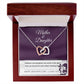 The Mother & Daughter-Never Truly Apart Interlocking Hearts Necklace in rose gold with cubic zirconia crystals comes in a wooden gift box. The insert reads "Mother & Daughter" and says: "Happy Mother's Day, I love you.