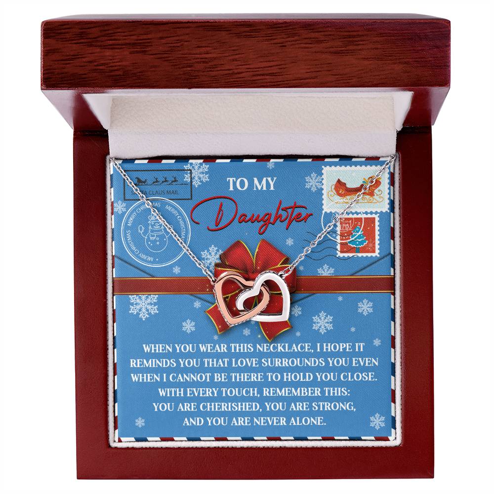 The Daughter-Remember This - Interlocking Hearts Necklace, made from surgical steel and adorned with cubic zirconia crystals, is presented in a wooden box. The inside lid includes a heartfelt message for a daughter, enhanced with decorative stamps and a ribbon design.