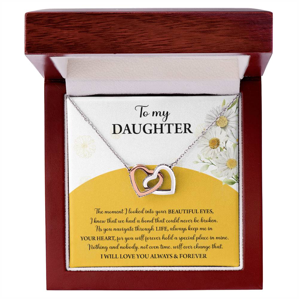 A box contains a "To Daughter, A Special Place - Interlocking Hearts Necklace" with cubic zirconia crystals. The message reads: "To my Daughter... Always keep me in your heart... Nothing brings me more joy than you. I will love you always & forever.