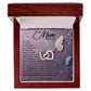 The Mom-Shining Star - Interlocking Hearts Necklace, adorned with cubic zirconia crystals, nestles in a luxury box featuring a heartfelt message to "Mom" surrounded by vibrant butterflies and floral patterns.