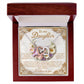 The Daughter-Heart Happiness Interlocking Hearts Necklace, with a rose gold finish and cubic zirconia-adorned hearts, comes in a "To my Daughter" wooden box featuring a heartfelt message framed by floral illustrations and a white interior.