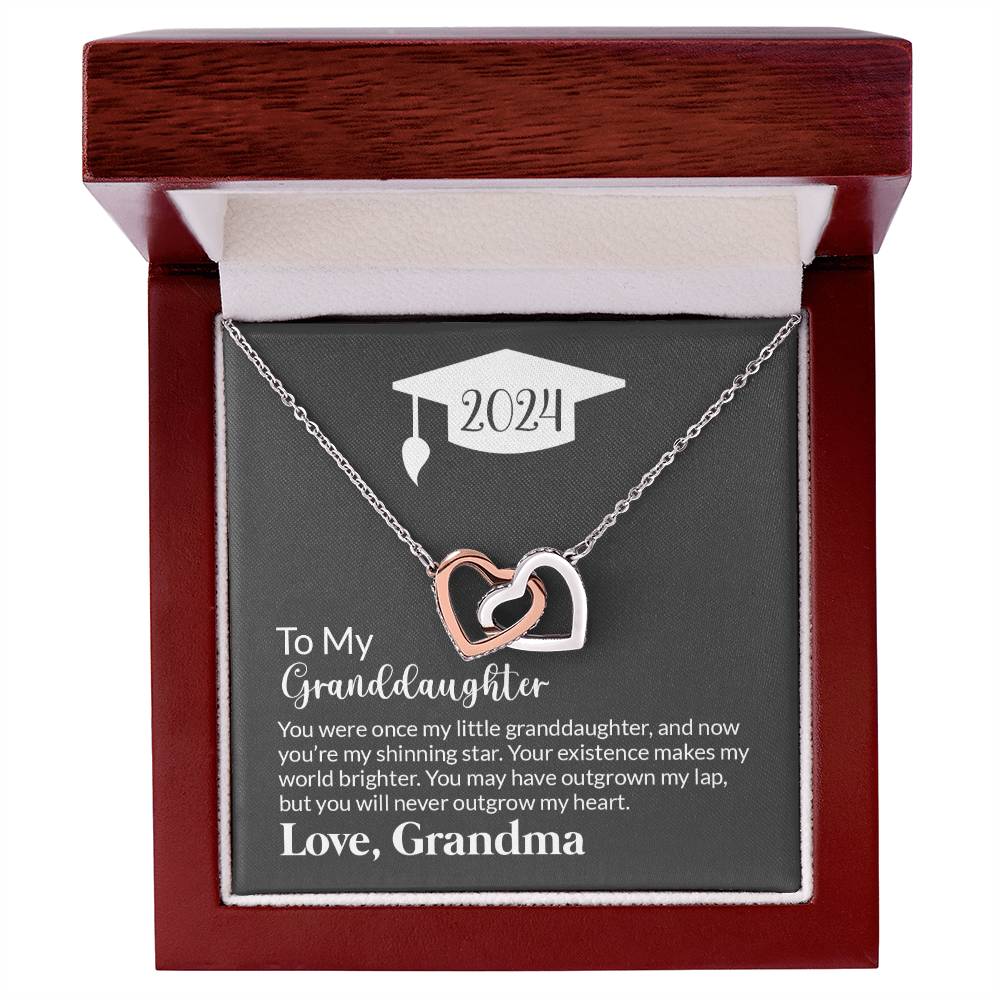 A gift box with a To My Granddaughter, Never Outgrow My Hearts - Interlocking Hearts Necklace and a heartfelt message to a granddaughter from her grandmother, commemorating the year 2024.