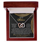 The Mom-Best Friend - Interlocking Hearts Necklace, featuring a rose gold finish and cubic zirconia crystals, is elegantly showcased in a wooden box. The message card reads "To my mom," conveying gratitude and love.
