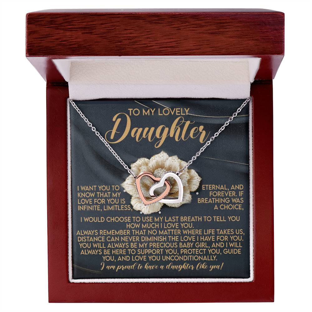 The Daughter-Infinite Love - Interlocking Hearts Necklace, adorned with cubic zirconia crystals, is displayed in an open red box. Inside, a message starts with "To My Lovely Daughter" in elegant script, conveying heartfelt love and support.