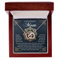 The Mom-Thankful Heart necklace is revealed in a dark wood jewelry box, featuring interlocking hearts with a rose gold finish and shimmering cubic zirconia crystals. The background card reads, "To my boyfriend's mom," expressing deep gratitude for her support and kindness.