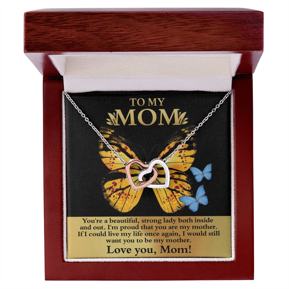The [Almost Sold Out] To Mom, Strong Lady - Interlocking Hearts Necklace features dazzling cubic zirconia crystals and comes in a wooden box with a heartfelt message on a butterfly background inside the lid, making it a truly unique gift.