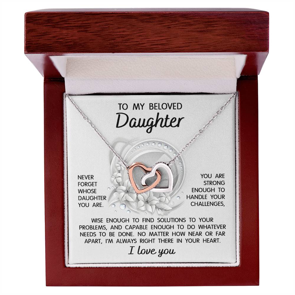 The "To Daughter, Always Right There - Interlocking Hearts Necklace" features a stunning interlocking hearts design with a rose gold finish and sparkling cubic zirconia crystals. It comes in a gift box that includes a heartfelt message for your beloved daughter, offering support, wisdom, and love.