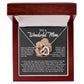 The Mom-More To Me Interlocking Hearts Necklace features a rose gold finish with cubic zirconia crystals in a wooden box. Inside, the message reads, "To a Wonderful Mom," with love and gratitude.