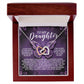 The Daughter-Moon Back - Interlocking Hearts Necklace, embellished with cubic zirconia crystals, is presented in a wooden box with a heartfelt inscription expressing endless love and pride. Its rose gold finish is beautifully complemented by purple and white butterflies.