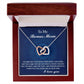 A jewelry box featuring the Bonus Mom-I Needed You - Interlocking Hearts Necklace in rose gold, set against a background with the message: "To My Bonus Mom. You may not have been there when I was born, but you came into my life exactly when I needed you most.”.