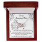 The "To Mom, Be My Mom - Interlocking Hearts Necklace," adorned with cubic zirconia, is packaged in a box showcasing a "my amazing mom" message and a decorative lion illustration, perfectly symbolizing love and admiration.