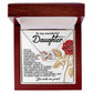 The Daughter-Journey Challenges Interlocking Hearts Necklace, featuring a rose gold finish, comes in a jewelry box with a heartfelt message for a daughter. The lid includes text and a red rose graphic. The wooden exterior and velvet interior enhance the elegance of this meaningful gift.