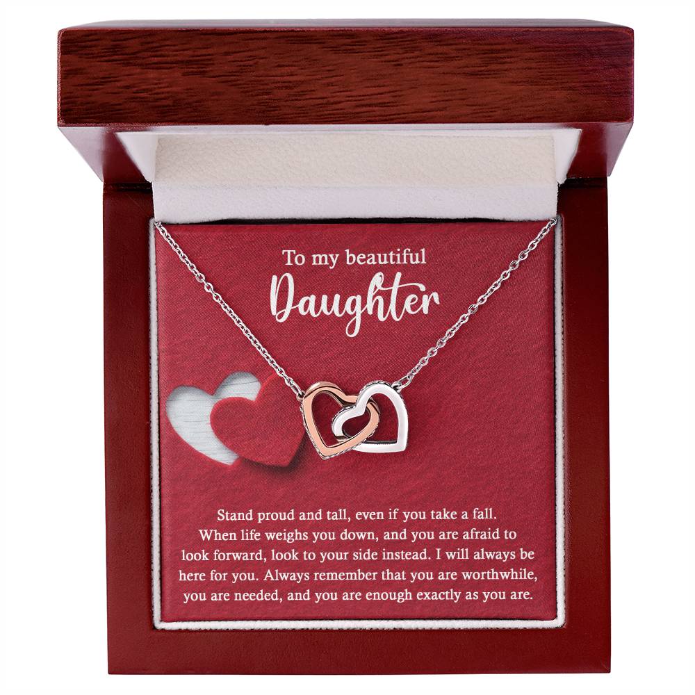 Introducing the elegant "To Daughter, As You Are 2 - Interlocking Hearts Necklace." This stunning piece features two intertwined hearts set against a red background and adorned with sparkling cubic zirconia crystals. The pendant holds the heartfelt message: "To my beautiful Daughter. Stand proud and tall, even if you take a fall..." Crafted from durable surgical steel, this necklace is designed to be both beautiful and enduring.