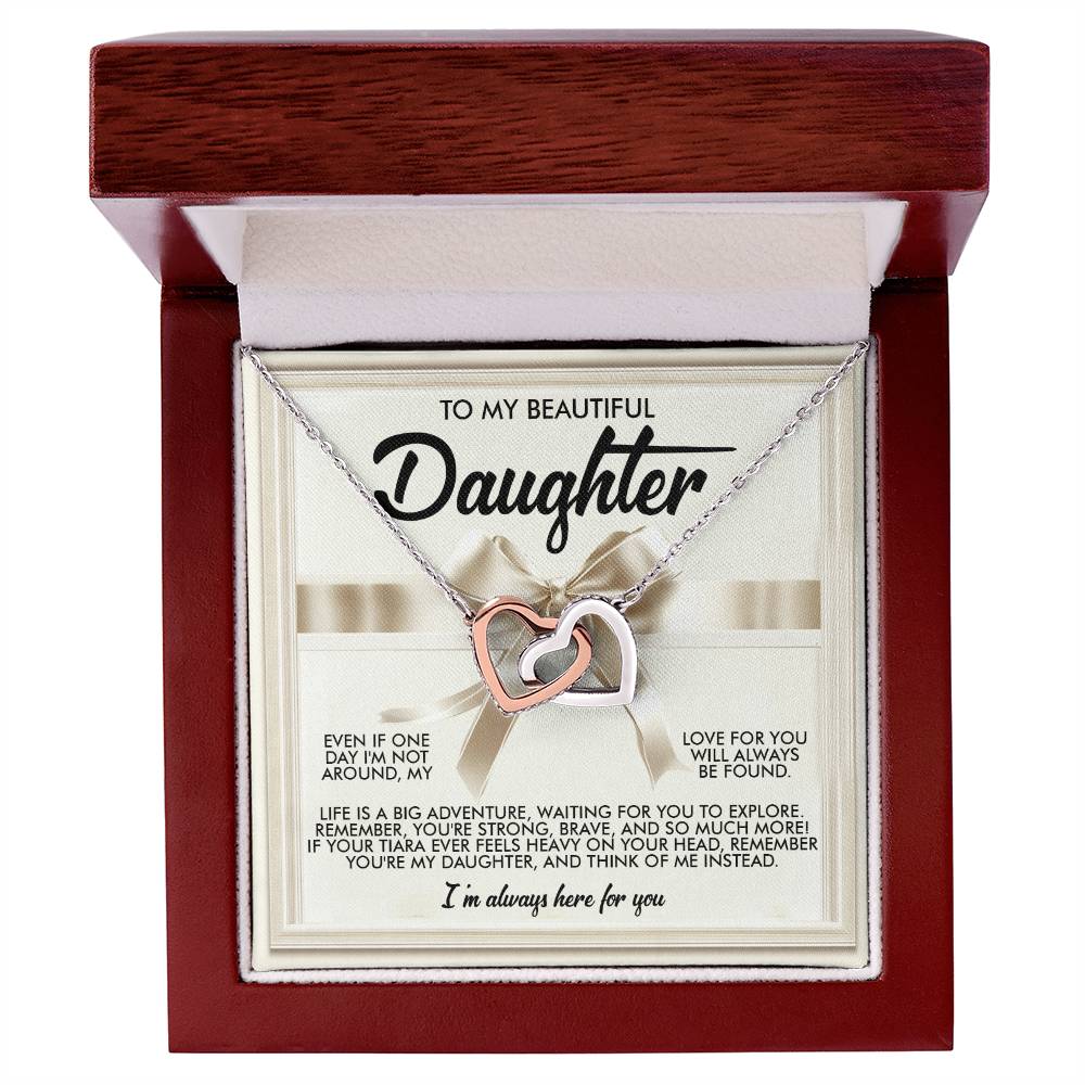 The Daughter-Heavy Tiara - Interlocking Hearts Necklace, featuring a rose gold finish and cubic zirconia crystals, is displayed in an open wooden box. The inner lid reads: "To My Beautiful Daughter," with a heartfelt message of love and support.