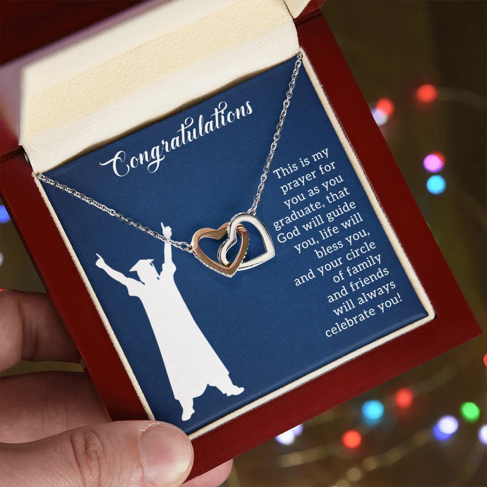 A graduation-themed ShineOn Fulfillment Interlocking Hearts necklace with an inspirational message in a gift box.