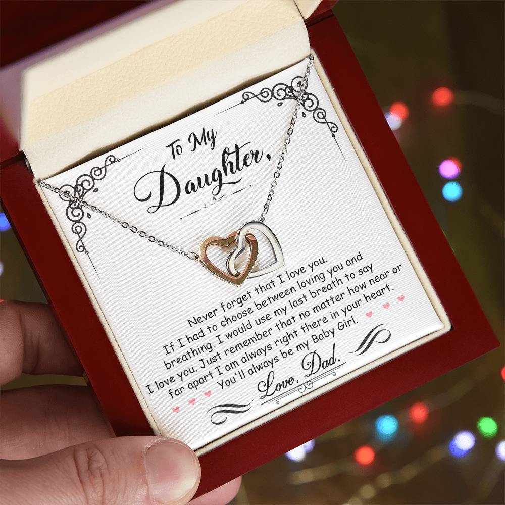 A hand holding a jewelry box with a "To My Daughter, I'm Always Right Here In Your Heart - Interlocking Hearts Necklace" from ShineOn Fulfillment and a sentimental message for a daughter from her dad.