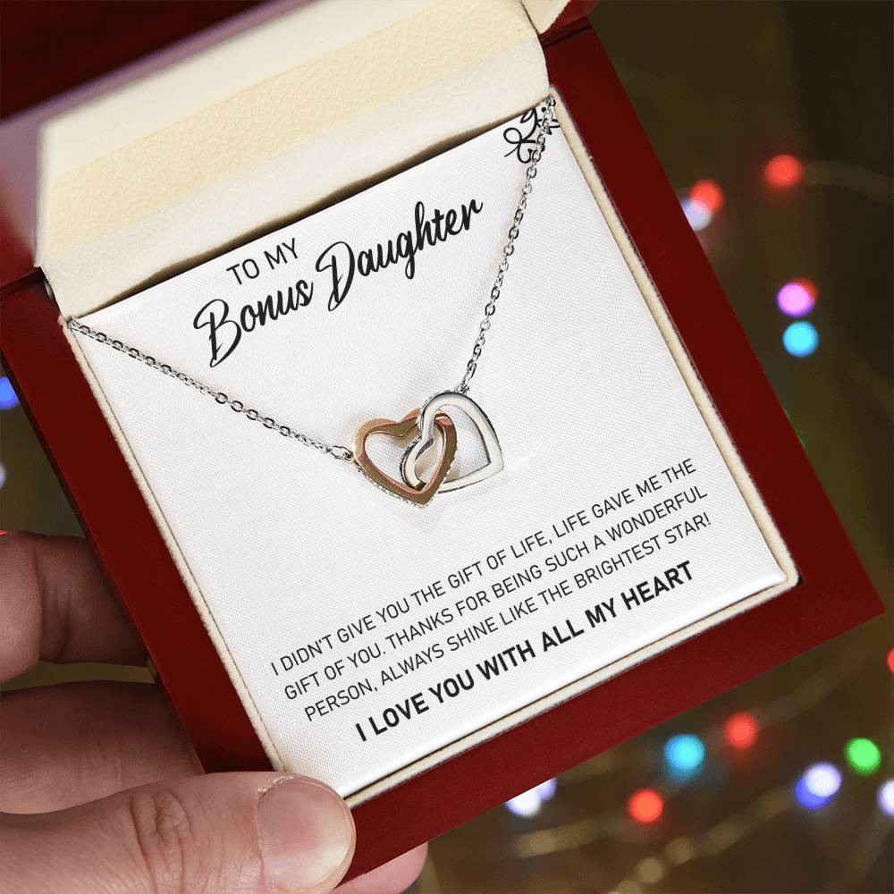 A To My Bonus Daughter, Always Shine Like The Brightest Star - Interlocking Hearts Necklace presented in a gift box with a heartfelt message from ShineOn Fulfillment.