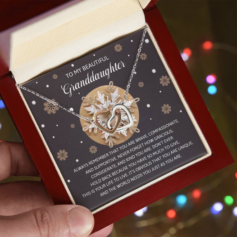 The "Granddaughter-As You Are - Interlocking Hearts Necklace" comes in a jewelry box with a message card that includes a motivational quote and snowflake design, making it a perfect gift for your granddaughter. The necklace's rose gold finish and sparkling cubic zirconia crystals provide an elegant touch to this heartfelt present.