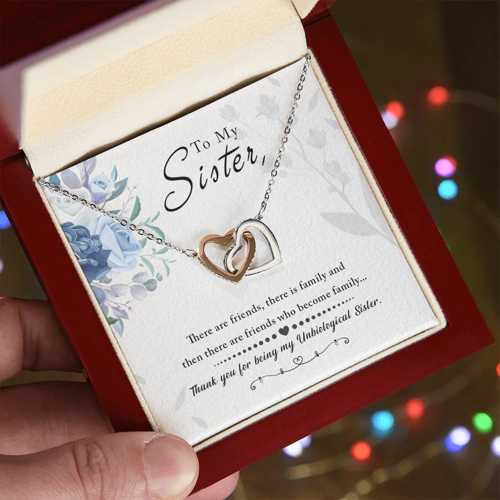 A hand holding a box with a "To My Sister, Thank You For Everything" interlocking hearts necklace from ShineOn Fulfillment and a sentimental note to a sister.
