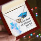A hand holding a red box with a Work Hard - Interlocking Hearts Necklace from ShineOn Fulfillment adorned with cubic zirconia crystals and an inspirational message that includes a bible verse.