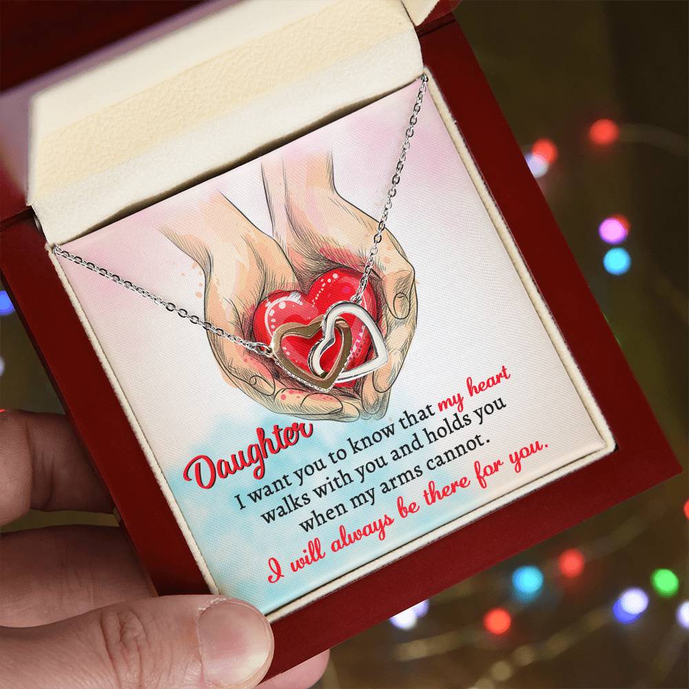 A high quality polished surgical steel necklace with two interlocking hearts is placed over an illustration of hands holding a red heart. Text reads: "Daughter, I want you to know that my heart walks with you and holds you when my arms cannot. I will always be there for you.
Product Name: To Daughter, Always Be There - Interlocking Hearts Necklace.