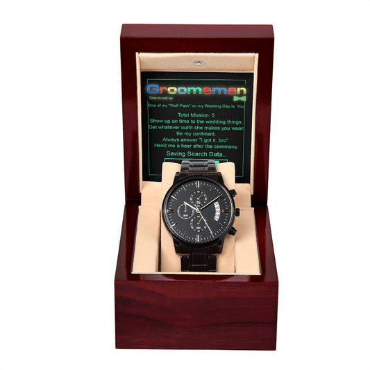 The "To Groomsman, Saving Search Data - Metal Chronograph Watch" in black with day and date display is elegantly presented in a wooden box with a beige interior. A card behind the watch reads "Groomsman, Time to Suit Up!" and provides specific instructions for the groomsman.