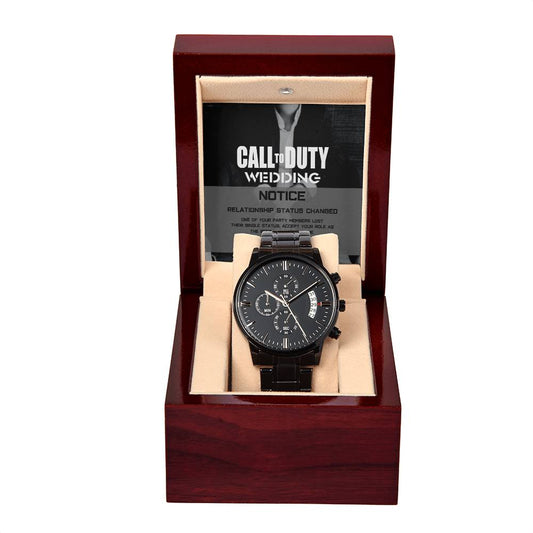 A black chronograph watch with multiple subdials and a date window is displayed in a dark brown wooden box. Behind the watch, a "To Best Man, Call to Duty - Metal Chronograph Watch" card is visible, highlighting the luxury copper dial that complements its sophisticated design.