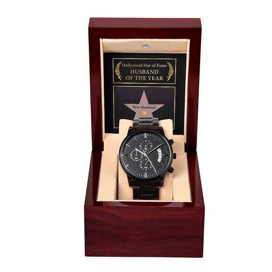 A "To Husband, Star of Fame - Metal Chronograph Watch" in black, presented in a red wooden box with a plaque behind it labeled "Hollywood Star of Fame - Husband of the Year.