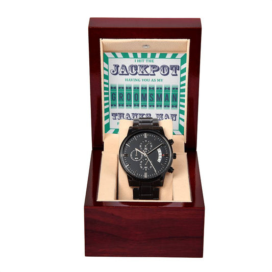 The "To Groomsman, Hit The Jackpot - Metal Chronograph Watch" is elegantly presented in a wooden box with a card inside, reading, "I hit the jackpot having you as my groomsman. Thanks, man." This luxury timepiece boasts a black chronograph design with a stainless steel case and an air of sophistication.