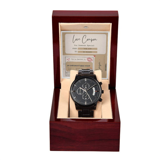 A black metal chronograph watch with a luxury copper dial comes in a red wooden box. Inside the lid, there's a small card labeled "Love Coupon" from the "To Husband, Coupon Book - Metal Chronograph Watch.