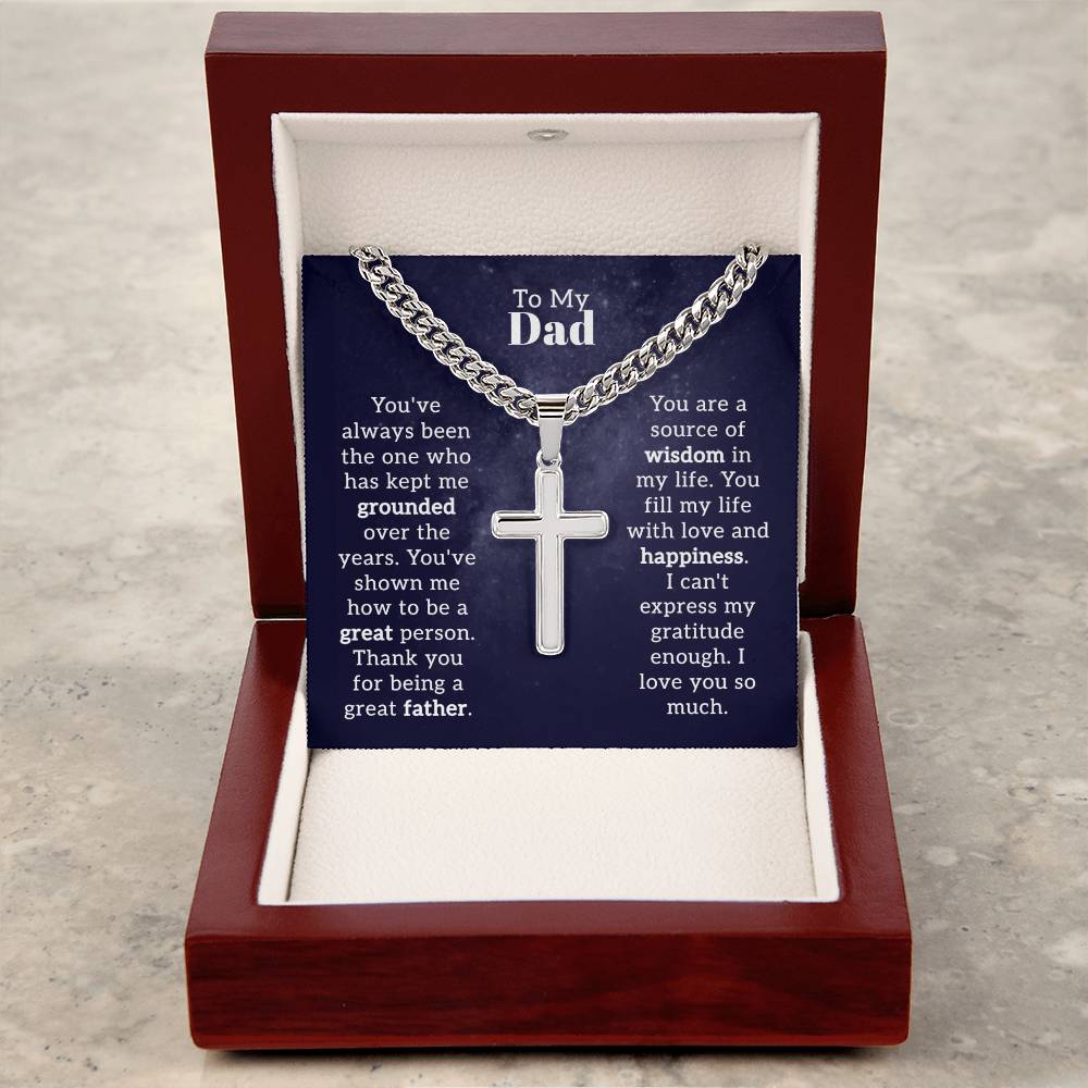 A "To Dad - Keep Me Grounded" necklace featuring a polished stainless steel, artisan cross pendant on a Cuban Link Chain presented in a gift box with an affectionate note by ShineOn Fulfillment for a father.