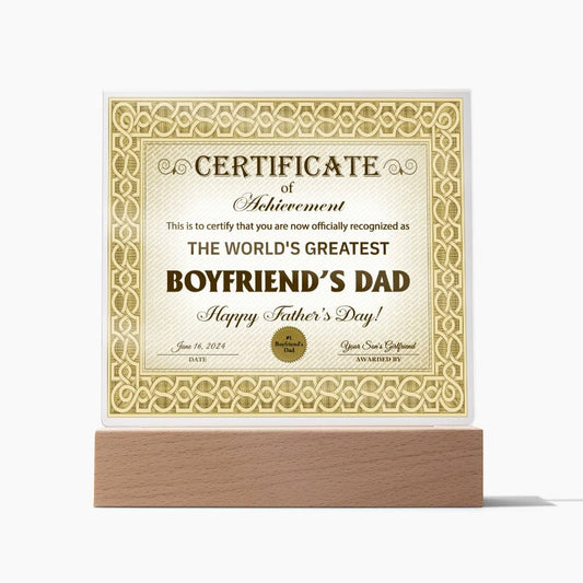 A framed certificate with ornate gold patterns, titled "To Boyfriend's Dad, Certificate Of Achievement - Acrylic Square Plaque," awarded for Father's Day on June 18, 2023. This sentimental gift also features a square acrylic plaque set on an elegant LED wooden base.