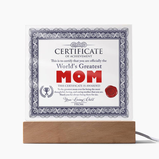 A framed To Mom, World's Greatest Mom Acrylic Square Plaque titled "certificate of achievement", with decorative borders, a seal, and signatures, standing on an LED wooden base.